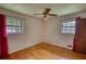 Cozy bedroom featuring hardwood floors, a ceiling fan, and windows with natural light at 1342 Peggy Nw Ln, Conyers, GA 30012