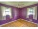 Bedroom with natural light, hardwood floors, and large windows with white curtains at 1342 Peggy Nw Ln, Conyers, GA 30012