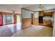 View of an open kitchen with wood cabinets, adjacent to a bright living area at 1342 Peggy Nw Ln, Conyers, GA 30012