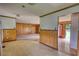 Open living area with wood paneling and transition to the kitchen space at 1342 Peggy Nw Ln, Conyers, GA 30012