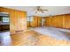 Spacious living room with wood paneling, built-in shelves, and ceiling fans at 1342 Peggy Nw Ln, Conyers, GA 30012