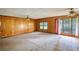 Large living room featuring wood paneling, carpet, and bright natural light at 1342 Peggy Nw Ln, Conyers, GA 30012