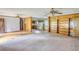 Open living area with wood paneling, kitchen access, and built-in shelving at 1342 Peggy Nw Ln, Conyers, GA 30012