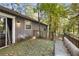 The exterior of the home shows the back deck covered in leaves, next to the home with gray siding at 1496 Meadowlark Dr, Decatur, GA 30032