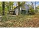 A view of the back of the house, showing the deck, gray siding, and a partially wooded lot at 1496 Meadowlark Dr, Decatur, GA 30032