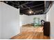 Unfinished basement with exposed ceiling and hardwood floors, ready for customization at 1496 Meadowlark Dr, Decatur, GA 30032
