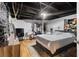 Bedroom with a black-painted ceiling and hardwood floors featuring a bed, TV, and accessories at 1496 Meadowlark Dr, Decatur, GA 30032