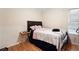 This cozy bedroom includes a double bed with bedding and a small side table at 1496 Meadowlark Dr, Decatur, GA 30032