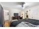 Comfortable bedroom featuring a ceiling fan, dresser with TV, and a connected bathroom at 1496 Meadowlark Dr, Decatur, GA 30032