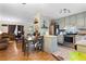 Eat-in kitchen open to the living room, featuring stainless steel appliances and tile backsplash at 1496 Meadowlark Dr, Decatur, GA 30032