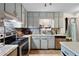 Kitchen with stainless steel appliances, light countertops and cabinets, and tile backsplash at 1496 Meadowlark Dr, Decatur, GA 30032