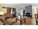 Inviting living area showcasing hardwood floors, stone fireplace, neutral paint, and lots of light at 1496 Meadowlark Dr, Decatur, GA 30032