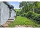 The home features light gray siding with a backyard and established landscaping at 2436 Clarissa Nw Dr, Atlanta, GA 30318