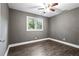 Cozy bedroom featuring hardwood floors, a ceiling fan, neutral walls, and bright windows at 2436 Clarissa Nw Dr, Atlanta, GA 30318