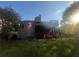 Back of a two-story home with a large back deck, American flag, yard swing, trees and a blue sky at 2580 Three Wood Dr, Villa Rica, GA 30180