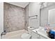 Bathroom featuring a bath tub and shower and a sink with a white cabinet at 1324 Almont Sw Dr, Atlanta, GA 30310