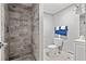 Bathroom featuring a toilet and a shower with marble-like tiling from the floor to the ceiling at 1324 Almont Sw Dr, Atlanta, GA 30310