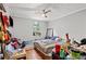 A bedroom with a bed, TV, ceiling fan, and an AC window unit at 1324 Almont Sw Dr, Atlanta, GA 30310