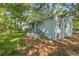 Exterior of home featuring siding, porch, stairs, and surrounded by trees in a spacious yard at 1324 Almont Sw Dr, Atlanta, GA 30310