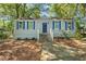 Charming single-story home featuring blue shutters and a well-maintained front yard at 1324 Almont Sw Dr, Atlanta, GA 30310