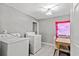Laundry room with two washers and a dryer beside the wall and small table at 1324 Almont Sw Dr, Atlanta, GA 30310