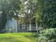 Charming blue cottage style home with a fenced yard surrounded by mature trees at 1417 Graymont Sw Dr, Atlanta, GA 30310