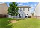Backyard featuring a well-maintained lawn, patio seating, and mature landscaping at 1742 Weatherbrook Cir, Lawrenceville, GA 30043