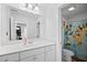Well-lit bathroom with a large vanity, ample storage, and a shower/tub combination with themed shower curtain at 1742 Weatherbrook Cir, Lawrenceville, GA 30043