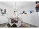 Chic dining room with seating for six, featuring hardwood floors and decorative accents on the walls at 1742 Weatherbrook Cir, Lawrenceville, GA 30043