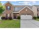 Charming two-story brick home with a well-manicured lawn and an attached two-car garage at 1742 Weatherbrook Cir, Lawrenceville, GA 30043