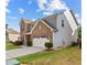 Stylish two-story home featuring a brick facade, gray siding, and a spacious two-car garage at 1742 Weatherbrook Cir, Lawrenceville, GA 30043