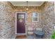 Cozy front porch with brickwork, adorned with decorative touches and seating for a welcoming entrance at 1742 Weatherbrook Cir, Lawrenceville, GA 30043