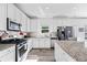 Updated kitchen featuring granite countertops, stainless steel appliances, and white cabinetry at 1742 Weatherbrook Cir, Lawrenceville, GA 30043