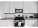 Well-equipped kitchen with stainless steel appliances, granite counters, and white cabinets at 1742 Weatherbrook Cir, Lawrenceville, GA 30043