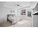 Bright main bedroom with tray ceilings, ceiling fan, carpet flooring, and shelving for decor or storage at 1742 Weatherbrook Cir, Lawrenceville, GA 30043