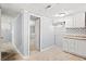 Unfinished basement kitchenette featuring white cabinets and gray walls at 3530 Fairlane Nw Dr, Atlanta, GA 30331