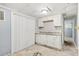 Basement kitchenette featuring white cabinets and gray walls at 3530 Fairlane Nw Dr, Atlanta, GA 30331