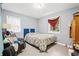 Neutral bedroom with a comfy bed, natural light, and a chair for relaxing at 3530 Fairlane Nw Dr, Atlanta, GA 30331