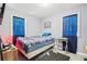 Cozy bedroom featuring blue curtains, a small desk, and soft lighting at 3530 Fairlane Nw Dr, Atlanta, GA 30331