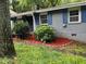 Charming home featuring painted brick, blue shutters, and a well-manicured front yard with mulch and greenery at 3530 Fairlane Nw Dr, Atlanta, GA 30331