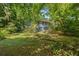 Back of house featuring partially fenced backyard and blue siding at 3530 Fairlane Nw Dr, Atlanta, GA 30331