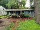 Quaint single-story home with grey brick, blue shutters, and well-landscaped front yard at 3530 Fairlane Nw Dr, Atlanta, GA 30331