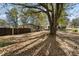A single-story home is pictured from across a partially shaded lawn with mature trees at 501 Aberdeen Nw Dr, Atlanta, GA 30318
