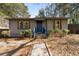 Charming single-story home with gray siding, blue door, and well-maintained landscaping at 501 Aberdeen Nw Dr, Atlanta, GA 30318