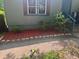 Freshly landscaped flowerbed with red mulch around the front of the house at 501 Aberdeen Nw Dr, Atlanta, GA 30318