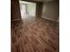 Spacious living room features modern wood-look flooring and neutral wall color at 4402 Highland Rd, Decatur, GA 30035