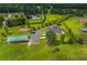 Aerial view showcases the home, detached structures, and landscaped grounds, complete with a trampoline at 500 Coleman Mill Rd, Carrollton, GA 30116