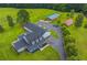Aerial view of home with well-manicured lawn, mature trees, and a long driveway leading to the property at 500 Coleman Mill Rd, Carrollton, GA 30116