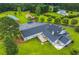 The aerial view shows a home with a deck and patio, surrounded by a green lawn and mature trees at 500 Coleman Mill Rd, Carrollton, GA 30116