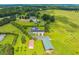 Stunning aerial view of the property, highlighting the house, surrounding greenery, and a large metal barn at 500 Coleman Mill Rd, Carrollton, GA 30116